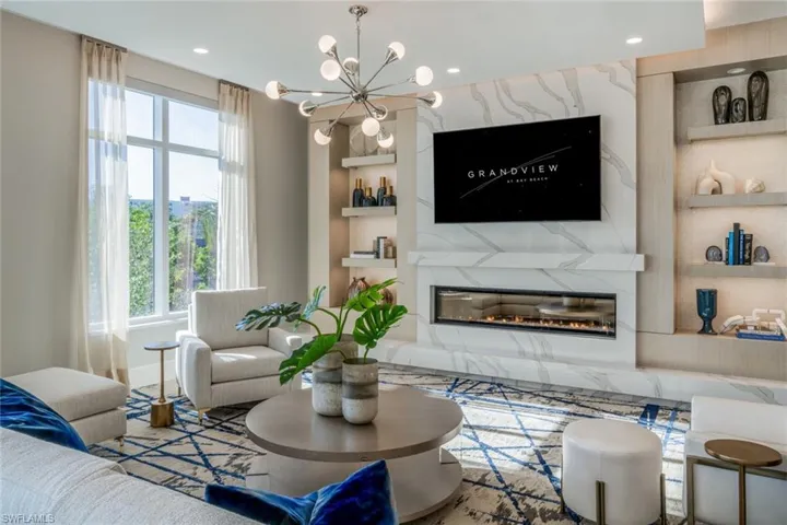 Located in the "EL" Stylish social room , with statement fireplace, built-in shelving, and spacious entertaining layout.