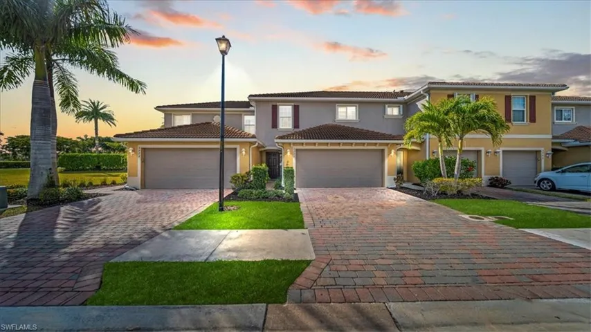 Mediterranean / spanish home featuring stucco siding, decorative driveway, a garage, and a tile roof