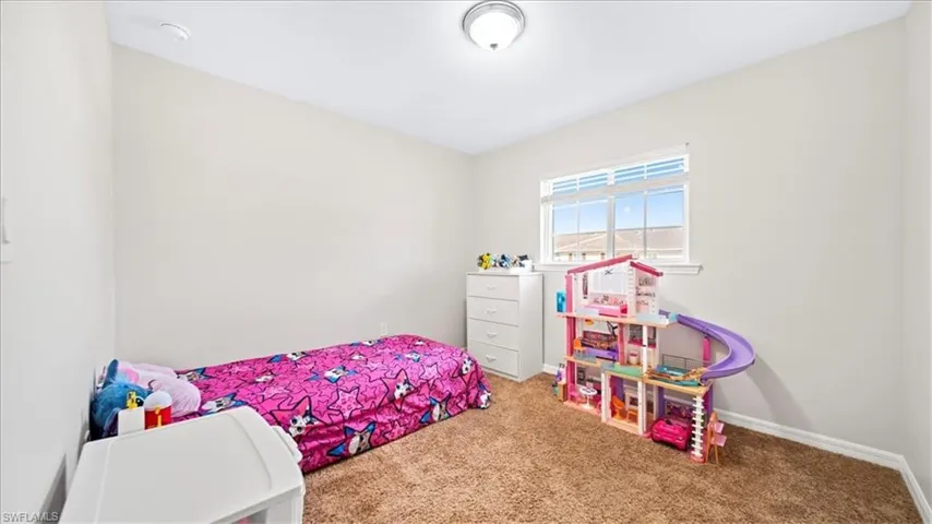 Carpeted bedroom with baseboards