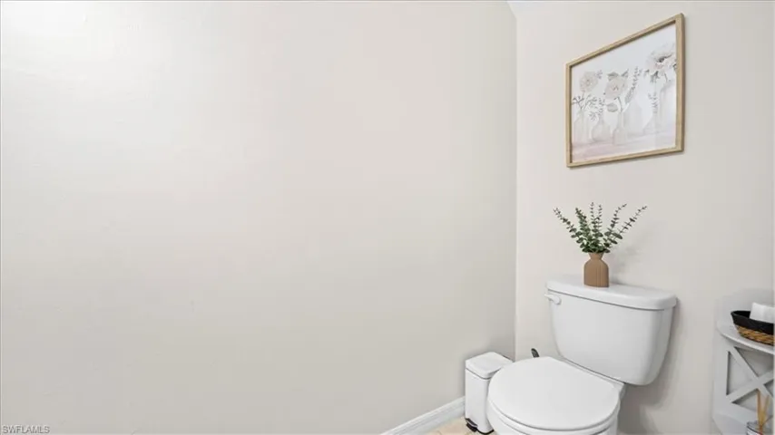 Bathroom with toilet and baseboards