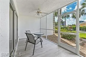 Unfurnished sunroom featuring a ceiling fan