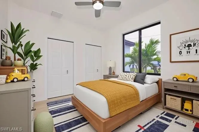 Bedroom with multiple closets and ceiling fan