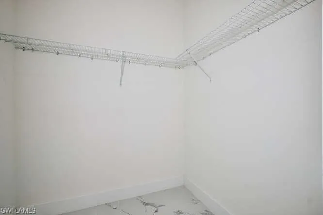 Spacious closet with marble finish flooring