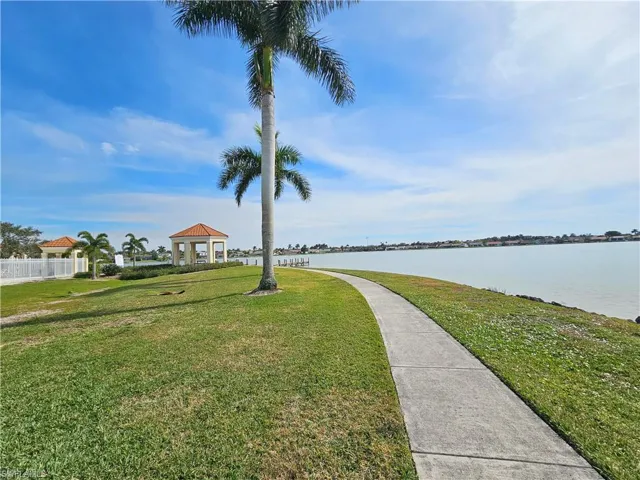 View of property's community featuring a lawn, a water view, and a gazebo