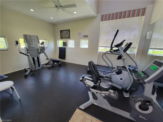 Exercise room featuring ceiling fan and a wealth of natural light