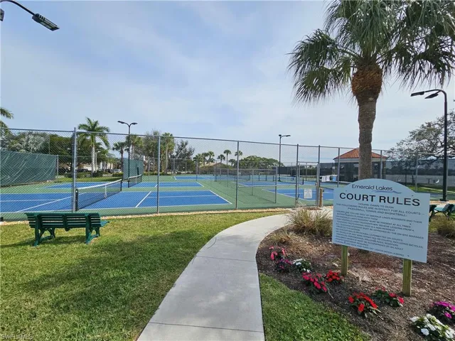 View of sport court featuring a lawn