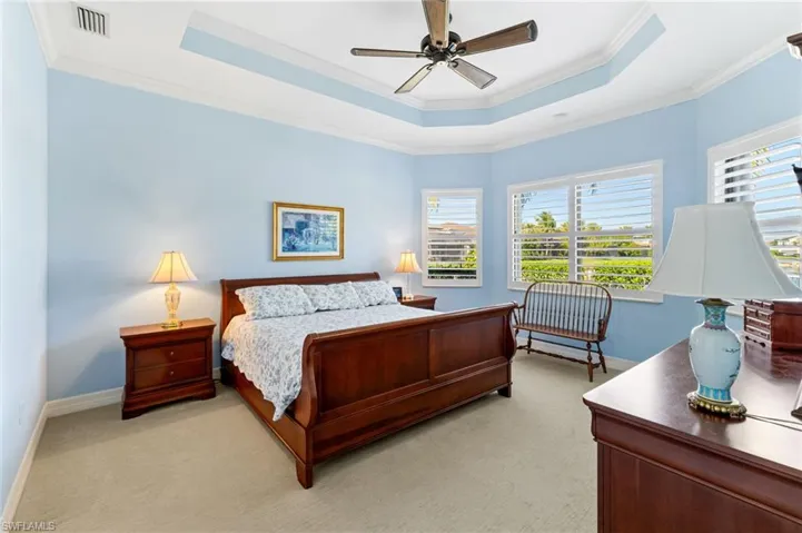 master bedroom features plantation shutters and crown molding