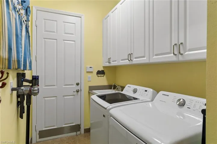 Laundry features sink and cabinetry