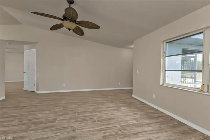 Spare room with ceiling fan and vaulted ceiling