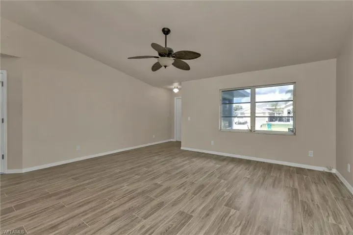 Spare room with ceiling fan and light wood-type flooring