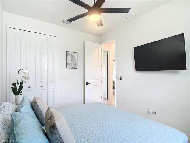 Bedroom featuring ceiling fan and a closet