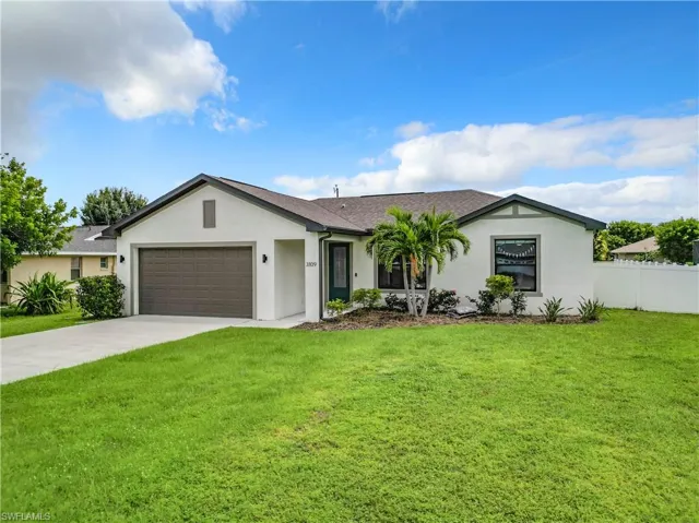 Ranch-style house with a front yard and a garage