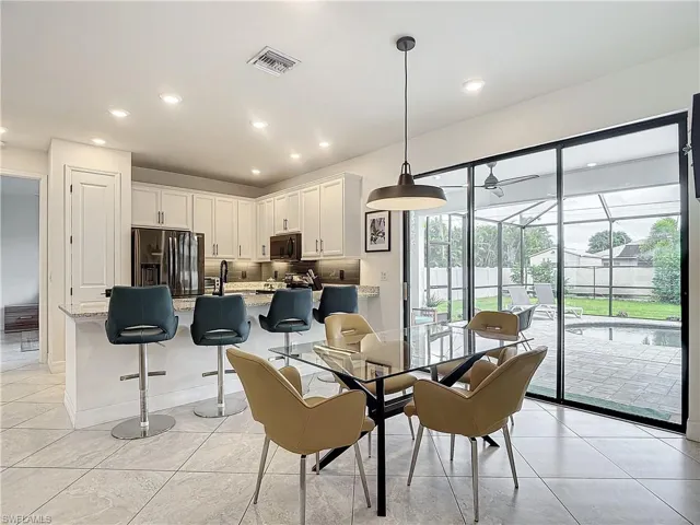 Tiled dining room featuring plenty of natural light