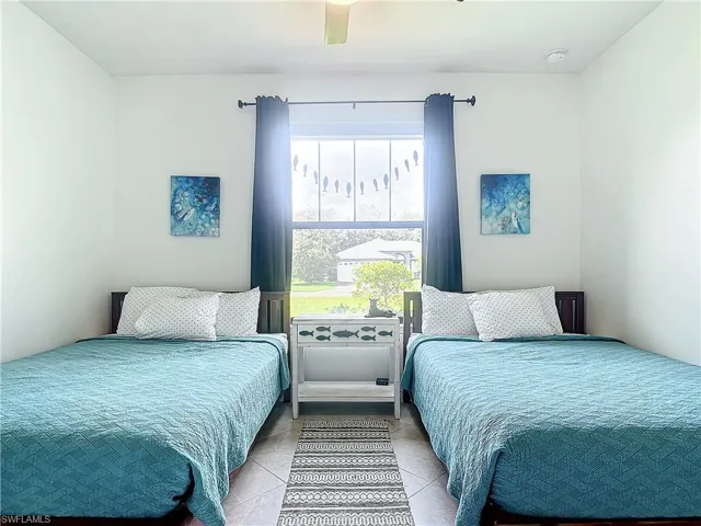 Bedroom featuring ceiling fan and light tile patterned floors