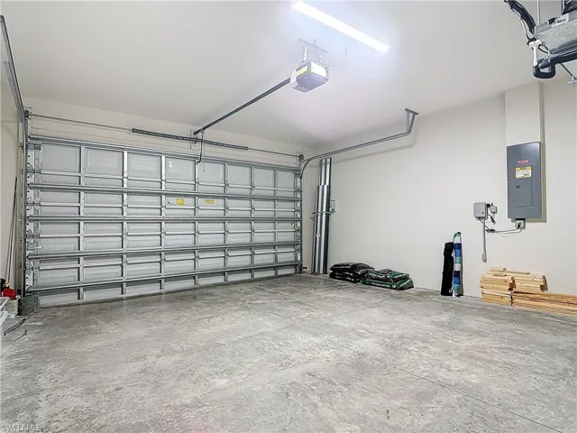 Garage with a garage door opener and electric panel