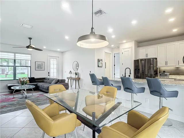 Dining space with ceiling fan and light tile patterned floors