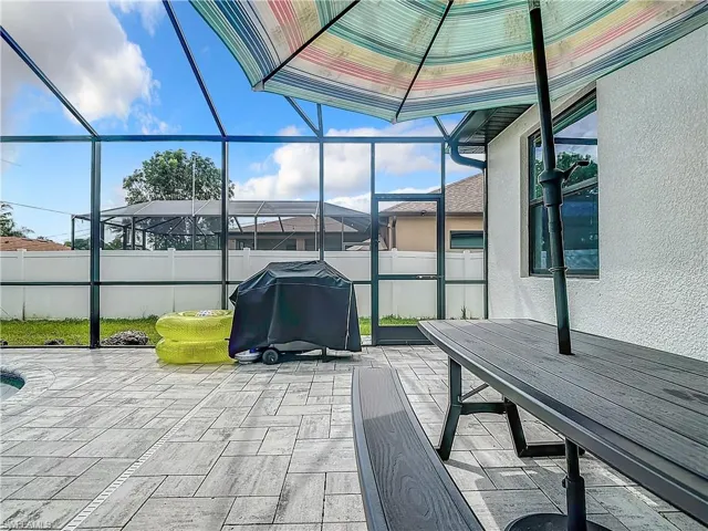 View of patio / terrace featuring glass enclosure and grilling area