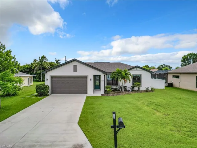 Ranch-style home with a front yard, a garage, and central air condition unit