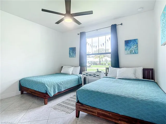 Bedroom featuring tile patterned flooring and ceiling fan