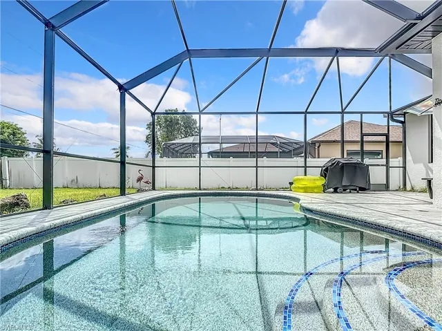 View of swimming pool featuring a lanai and a patio area