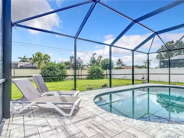 View of pool with a lawn, a lanai, and a patio area