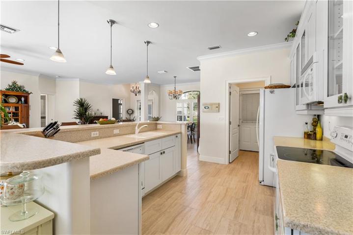 Solid surface countertops. White appliances.