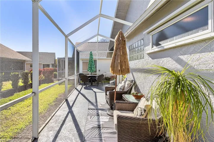 Sunroom with outdoor dining area and a patio area