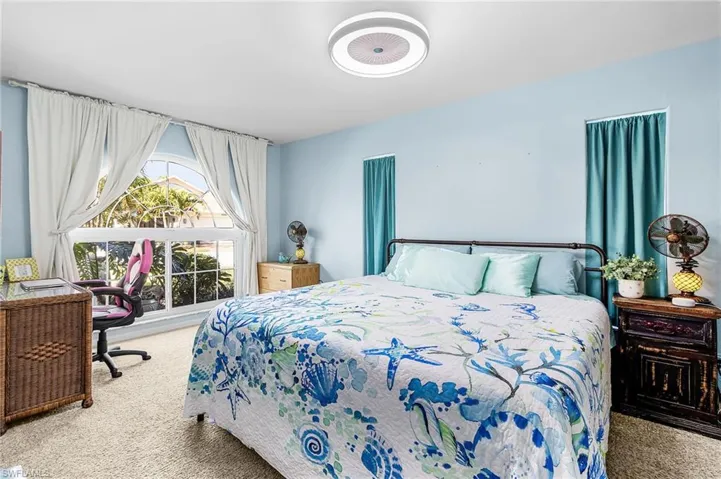 Bedroom featuring carpet flooring and an office area