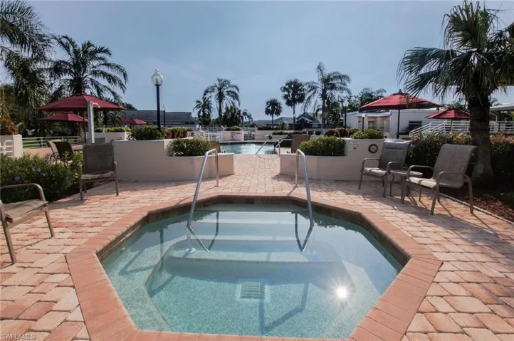 Community pool featuring a patio and a community hot tub