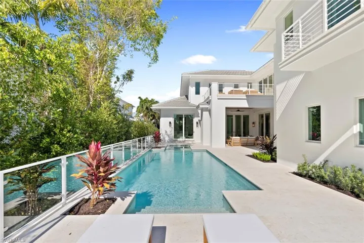 Swimming pool featuring a balcony, a patio, and outdoor lounge area