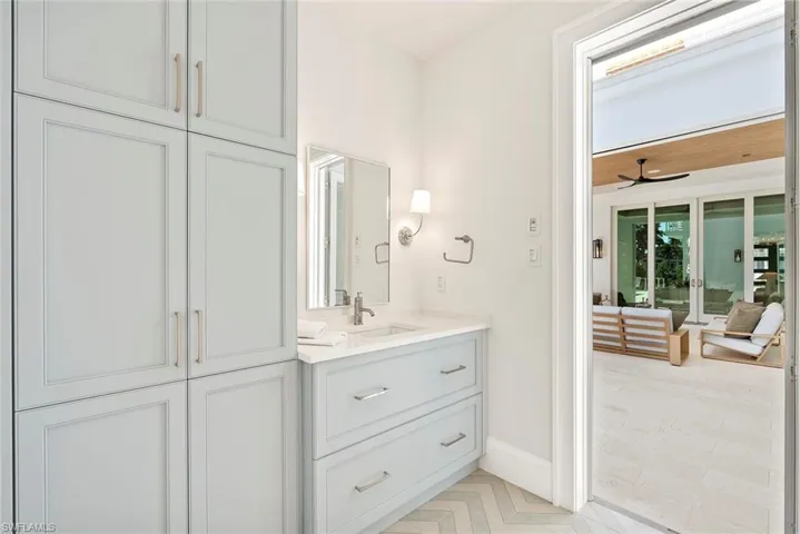 Bathroom featuring vanity and a ceiling fan