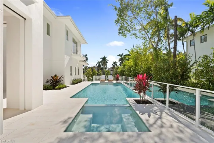 View of swimming pool with a patio area and a pool with connected hot tub