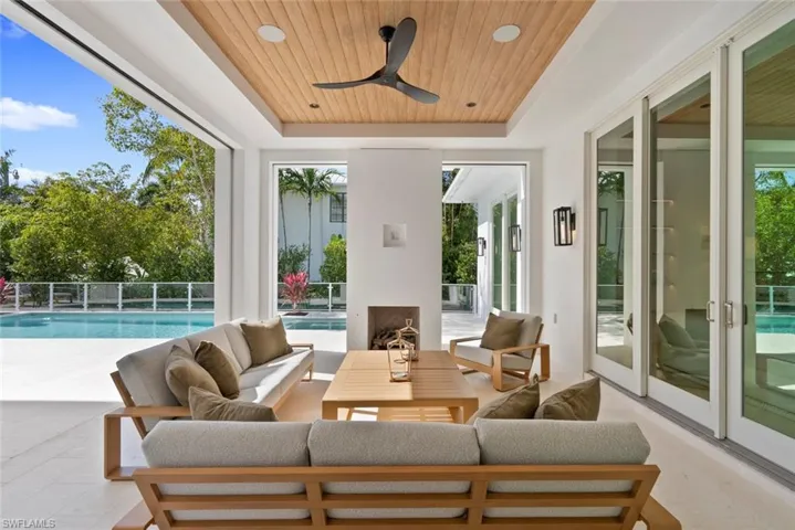 Sunroom featuring healthy amount of natural light and a swimming pool