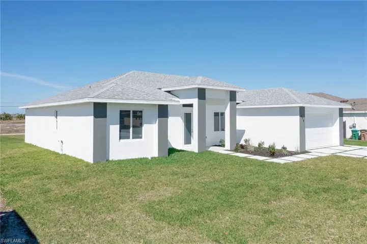 Prairie-style house with a front yard and a garage