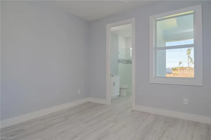 Empty room with light hardwood / wood-style flooring