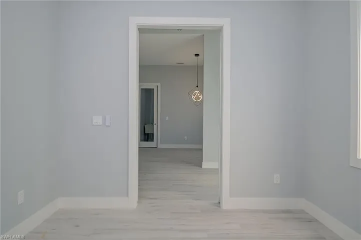 Corridor featuring light wood-type flooring
