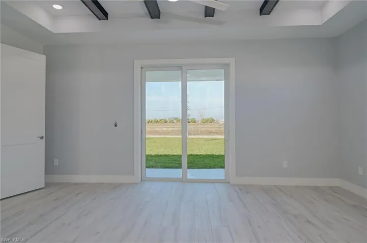 Empty room with light hardwood / wood-style floors