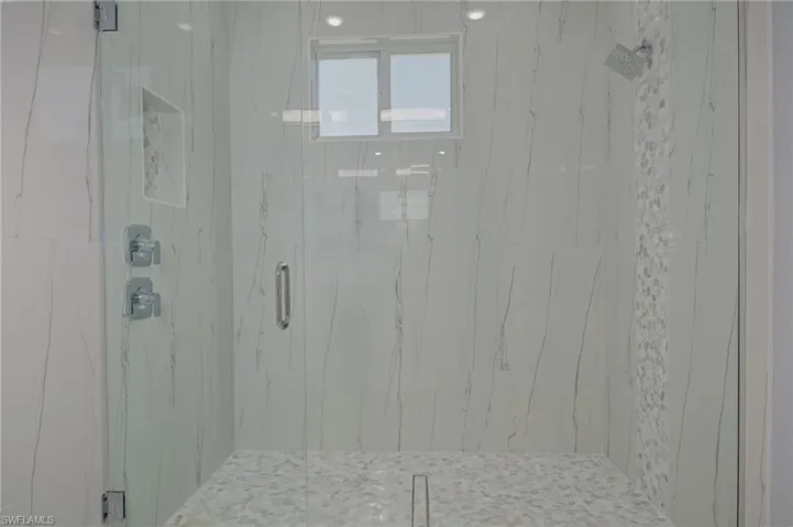 Bathroom with a shower with door