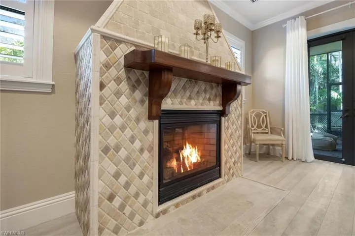 Interior details with a fireplace, hardwood / wood-style floors, and ornamental molding