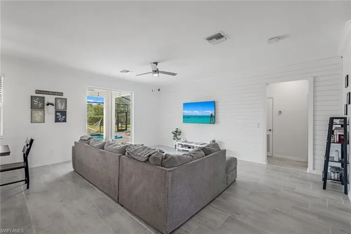 Living area featuring baseboards, a ceiling fan, and visible vents
