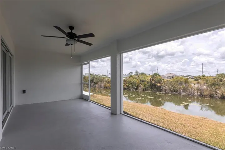 Unfurnished sunroom featuring a water view