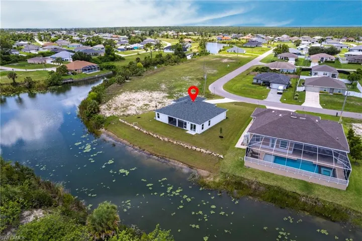 Aerial perspective of suburban area with a nearby body of water