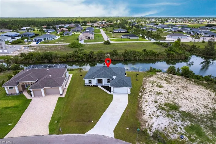 Aerial perspective of suburban area with a large body of water