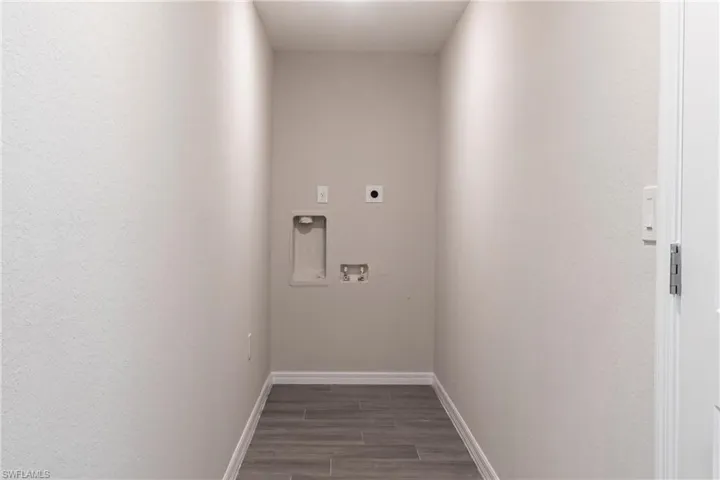 Laundry room featuring hookup for an electric dryer, washer hookup, and dark wood finished floors