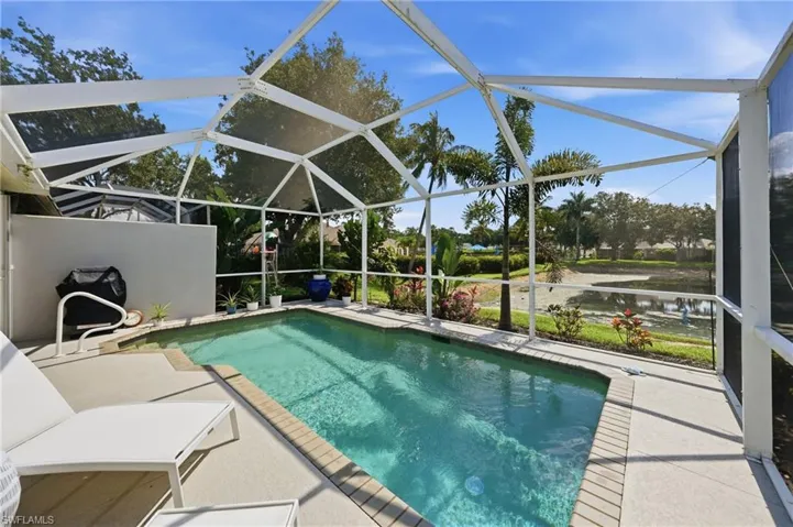 Screened-in swimming pool with a concrete paver surround