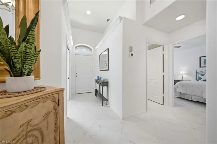 Bright entryway featuring white tile flooring