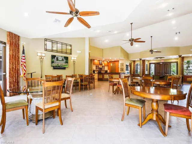 Spacious common area featuring tiled flooring, vaulted ceilings with ceiling fans, and recessed lighting