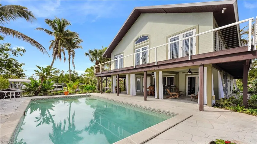 Rear view of property with a balcony, ceiling fan, and a patio area
