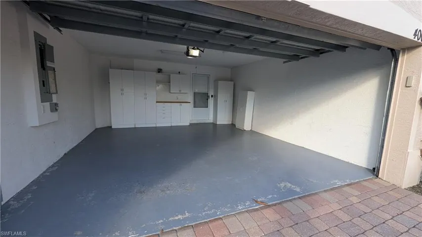 Garage featuring a textured wall and electric panel