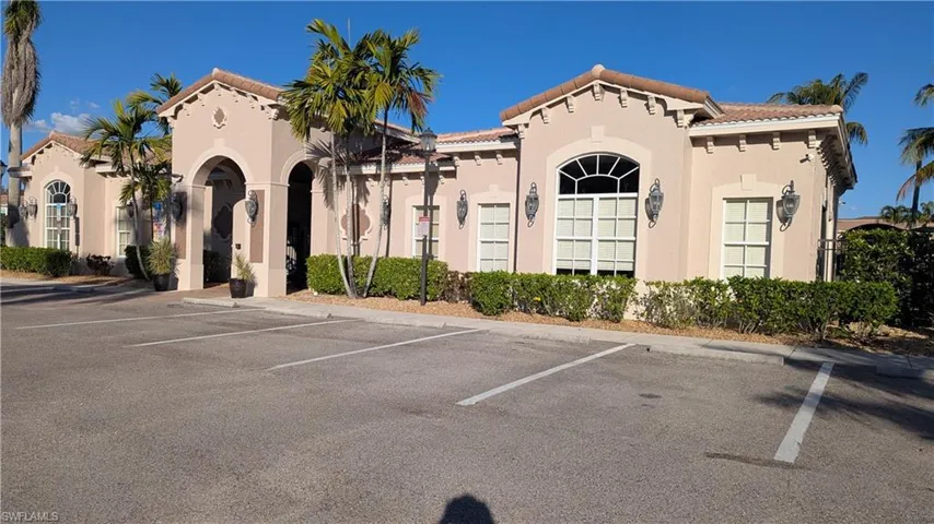 View of property with uncovered parking